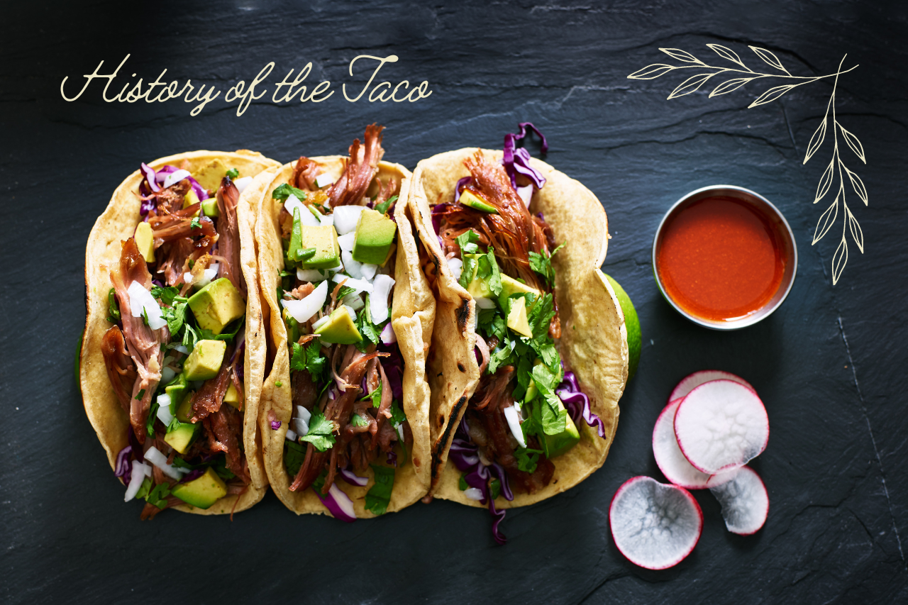 three tacos on a black slate background